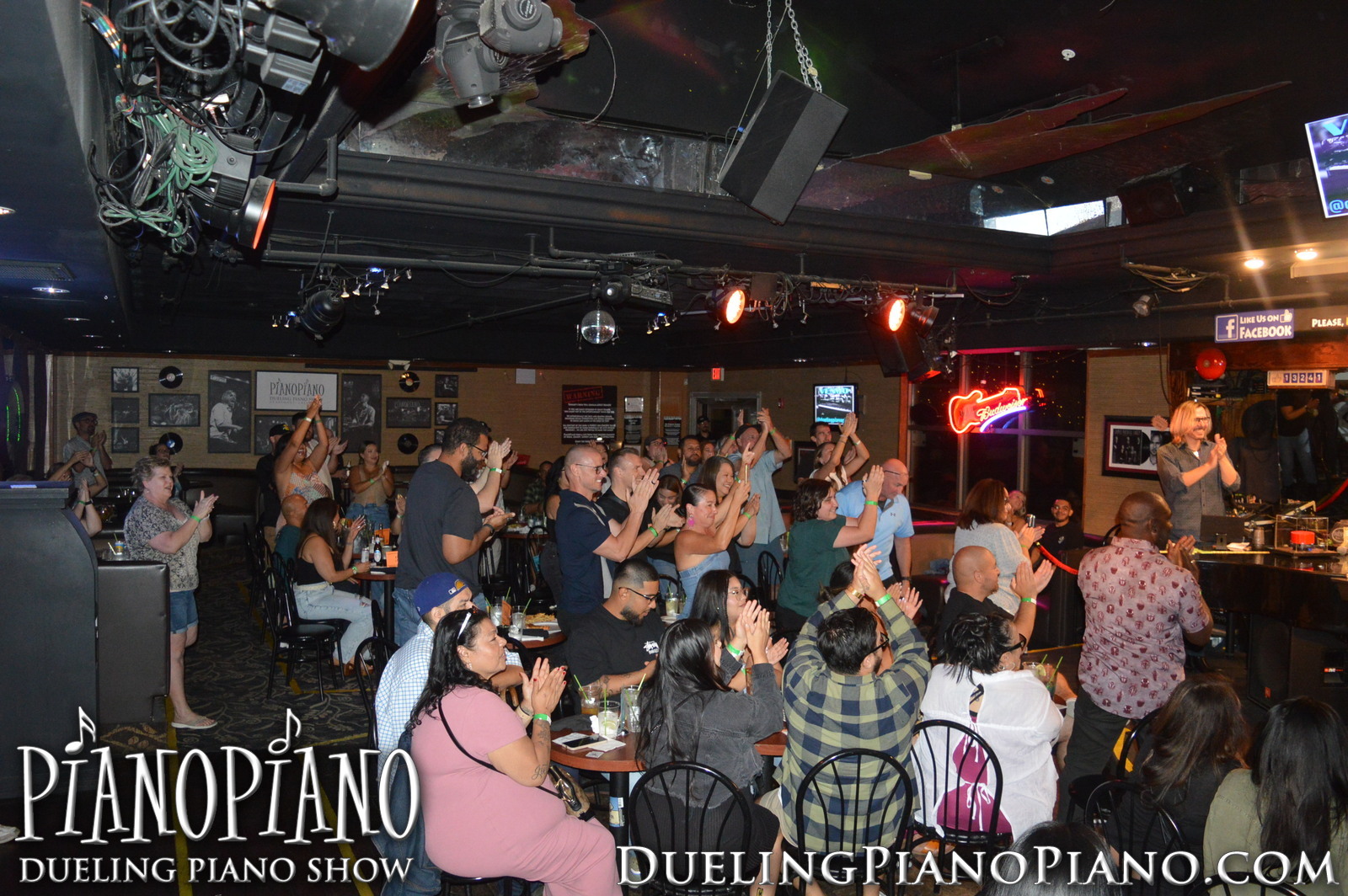 Wide view of an energetic crowd enjoying the PianoPiano show