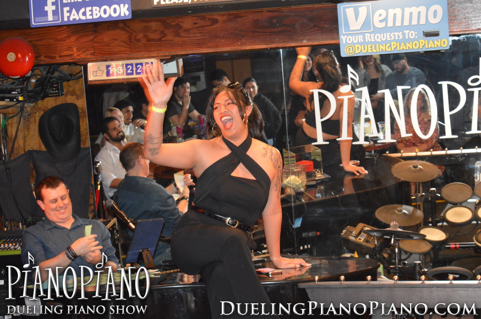Guest waving while participating onstage at PianoPiano